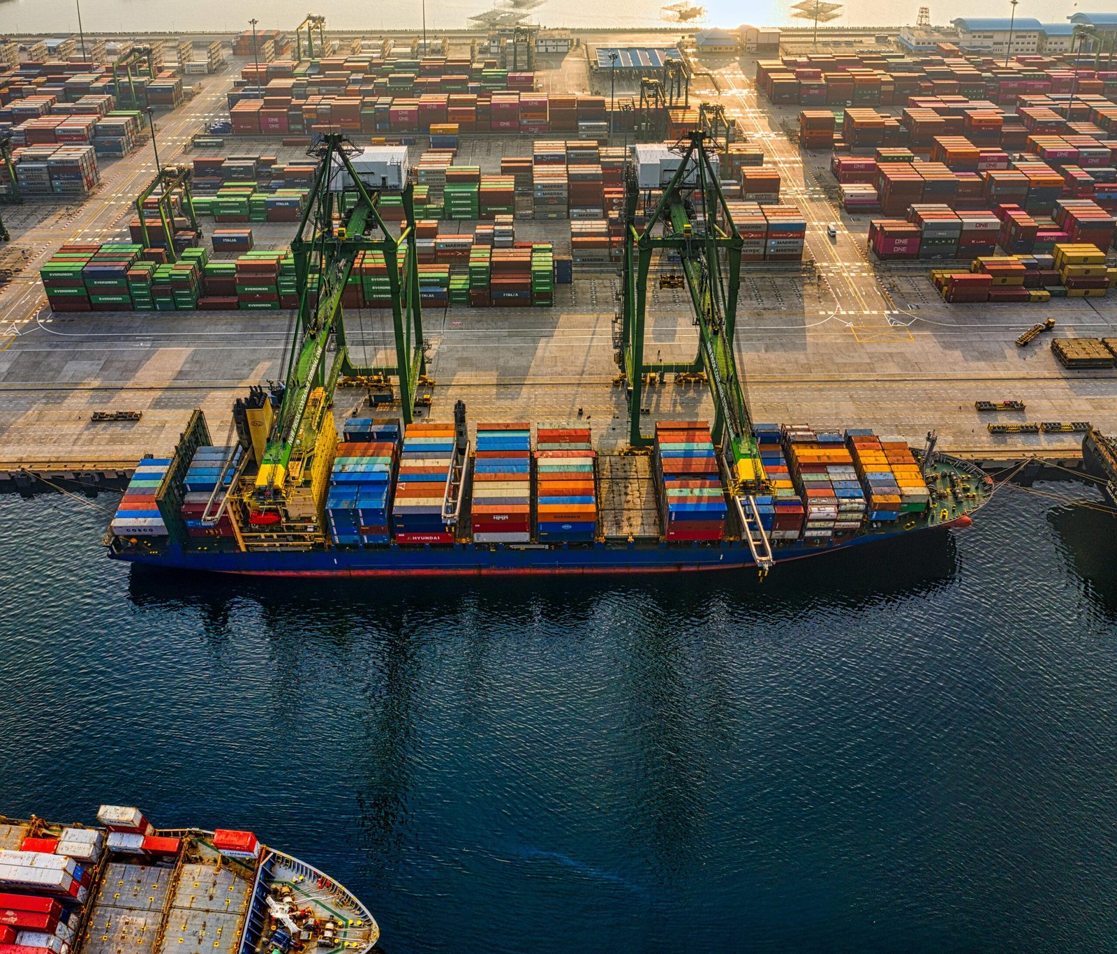 Aerial shot of colorful shipping containers at North Jakarta's bustling port, Indonesia.